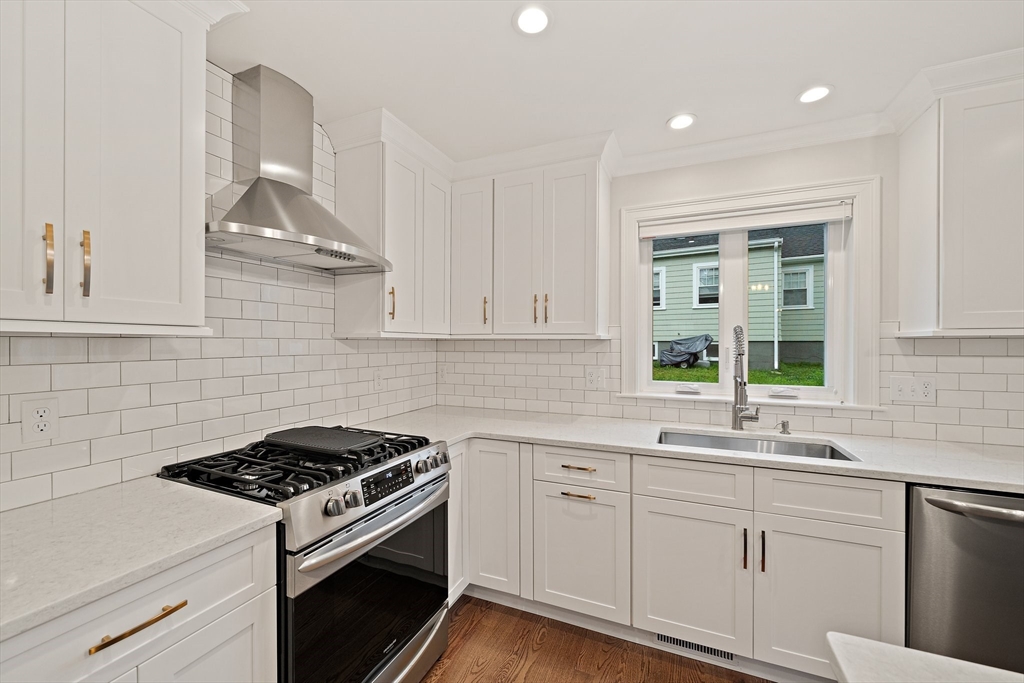15 Lakeview Avenue Waltham, MA 02451 - Photo 15 of 34 a kitchen with white cabinets and appliances