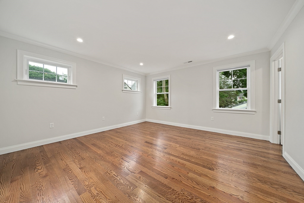 15 Lakeview Avenue Waltham, MA 02451 - Photo 17 of 34 a view of an empty room with wooden floor and a window
