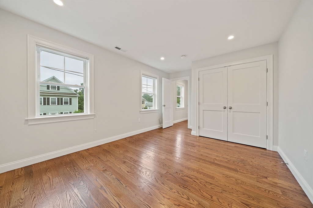 15 Lakeview Avenue Waltham, MA 02451 - Photo 23 of 34 a view of empty room with wooden floor and window