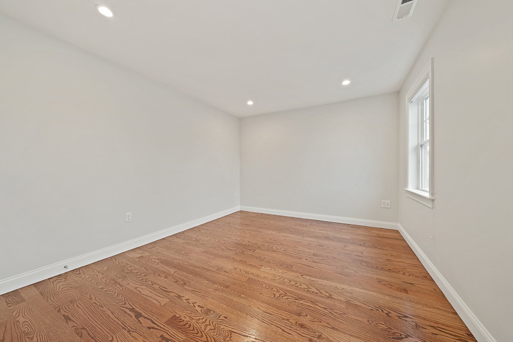 15 Lakeview Avenue Waltham, MA 02451 - Photo 24 of 34 a view of an empty room with wooden floor and a window
