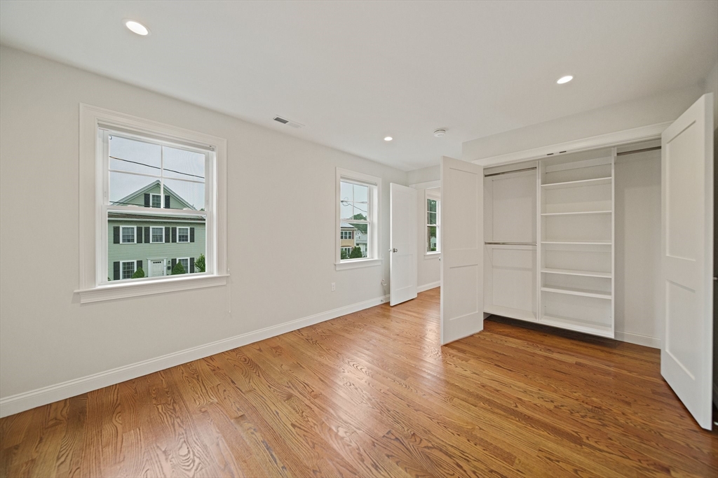 15 Lakeview Avenue Waltham, MA 02451 - Photo 25 of 34 a view of an empty room with wooden floor and a window