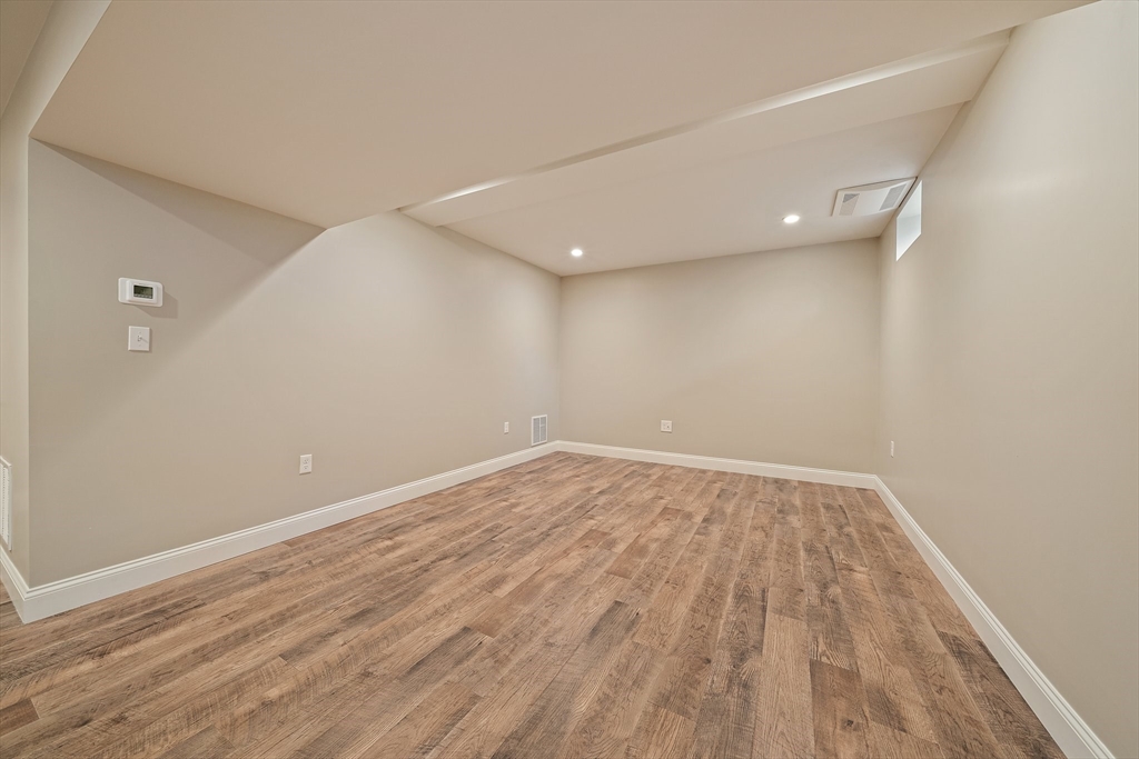 15 Lakeview Avenue Waltham, MA 02451 - Photo 32 of 34 a view of an empty room with wooden floor