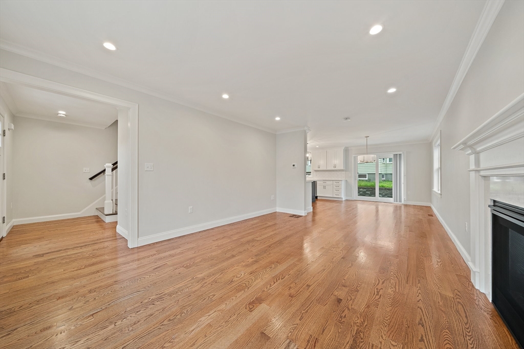 15 Lakeview Avenue Waltham, MA 02451 - Photo 6 of 34 a view of empty room with wooden floor and fireplace