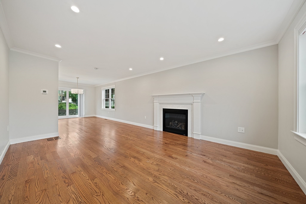 15 Lakeview Avenue Waltham, MA 02451 - Photo 7 of 34 a view of empty room with wooden floor and fireplace