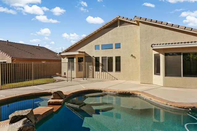 a front view of a house with swimming pool and porch