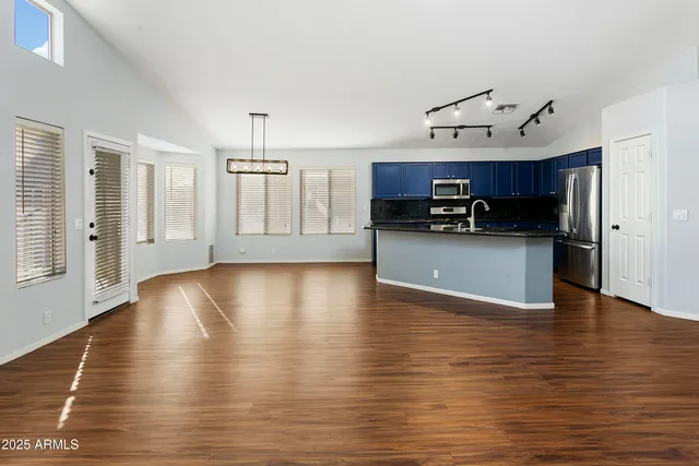a view of a kitchen with a sink cabinets and wooden floor