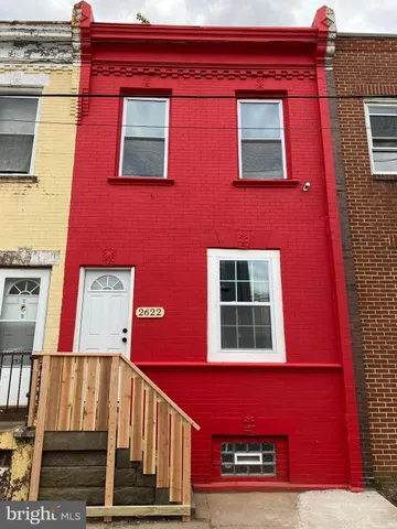 a view of a building with a small yard