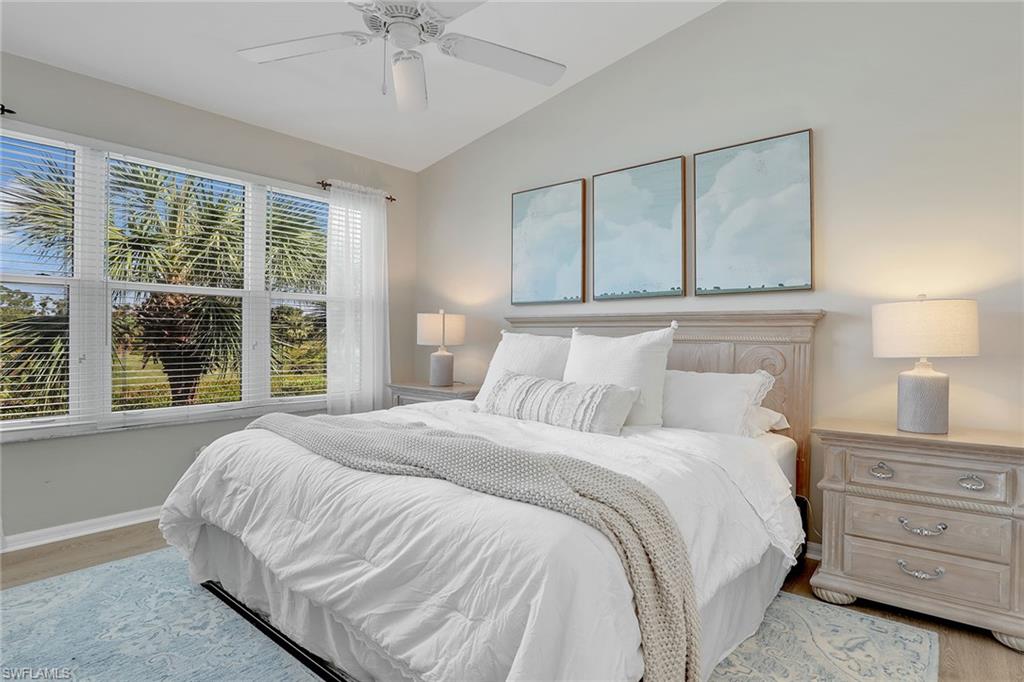 9189 Spring Run Boulevard, Unit 1908 Estero, FL 34135 - Photo 11 of 33 a bedroom with a bed and a chandelier