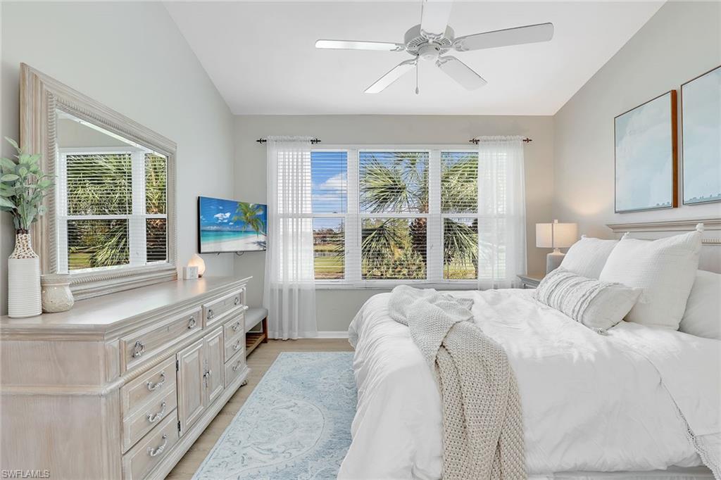 9189 Spring Run Boulevard, Unit 1908 Estero, FL 34135 - Photo 12 of 33 a spacious bedroom with a bed and a large window