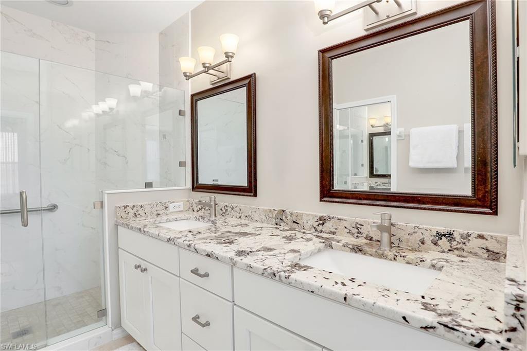 9189 Spring Run Boulevard, Unit 1908 Estero, FL 34135 - Photo 13 of 33 a bathroom with a sink and a mirror