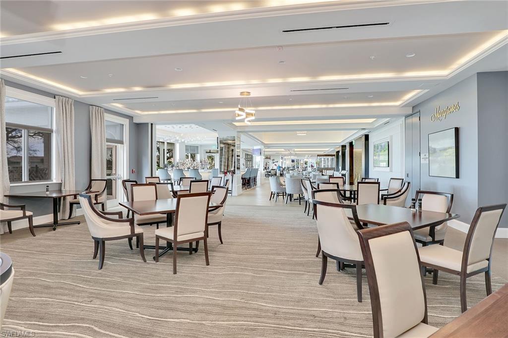 9189 Spring Run Boulevard, Unit 1908 Estero, FL 34135 - Photo 23 of 33 a dining room with furniture window and wooden floor