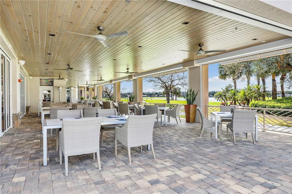9189 Spring Run Boulevard, Unit 1908 Estero, FL 34135 - Photo 25 of 33 a outdoor space with lots of tables a garden view and chairs