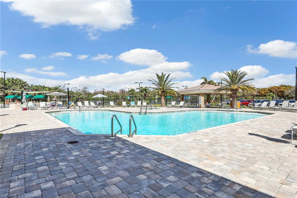 9189 Spring Run Boulevard, Unit 1908 Estero, FL 34135 - Photo 27 of 33 a view of swimming pool with outdoor seating and lake view