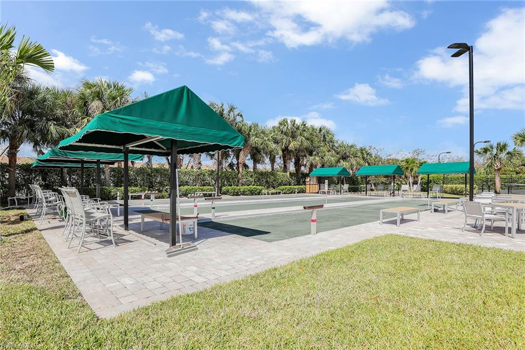 9189 Spring Run Boulevard, Unit 1908 Estero, FL 34135 - Photo 28 of 33 a swimming pool with outdoor seating and yard