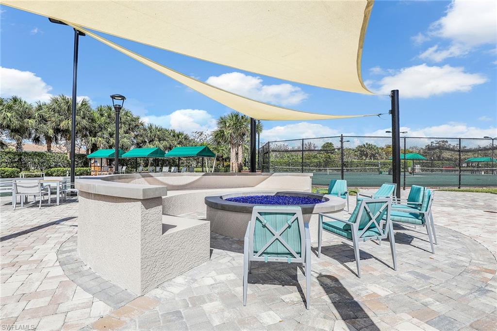 9189 Spring Run Boulevard, Unit 1908 Estero, FL 34135 - Photo 29 of 33 a view of chairs and tables in the patio