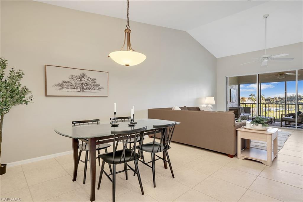 9189 Spring Run Boulevard, Unit 1908 Estero, FL 34135 - Photo 3 of 33 a view of a dining room with furniture large windows and a chandelier