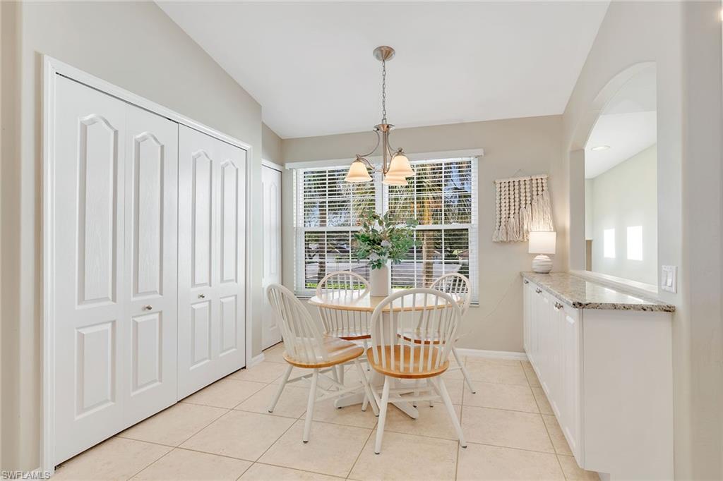 9189 Spring Run Boulevard, Unit 1908 Estero, FL 34135 - Photo 6 of 33 a view of a livingroom with furniture wooden floor a chandelier