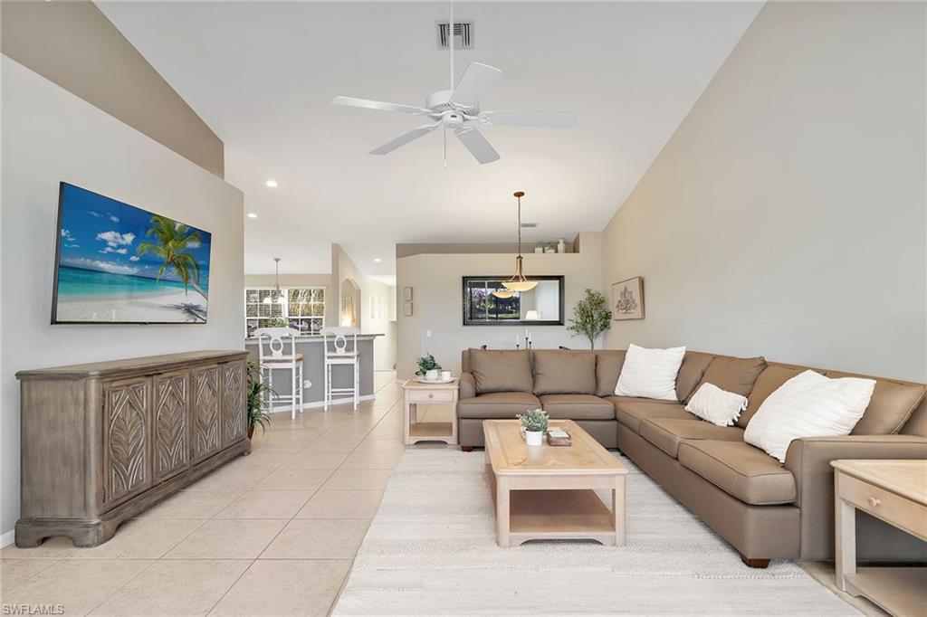 9189 Spring Run Boulevard, Unit 1908 Estero, FL 34135 - Photo 8 of 33 a living room with furniture and a chandelier