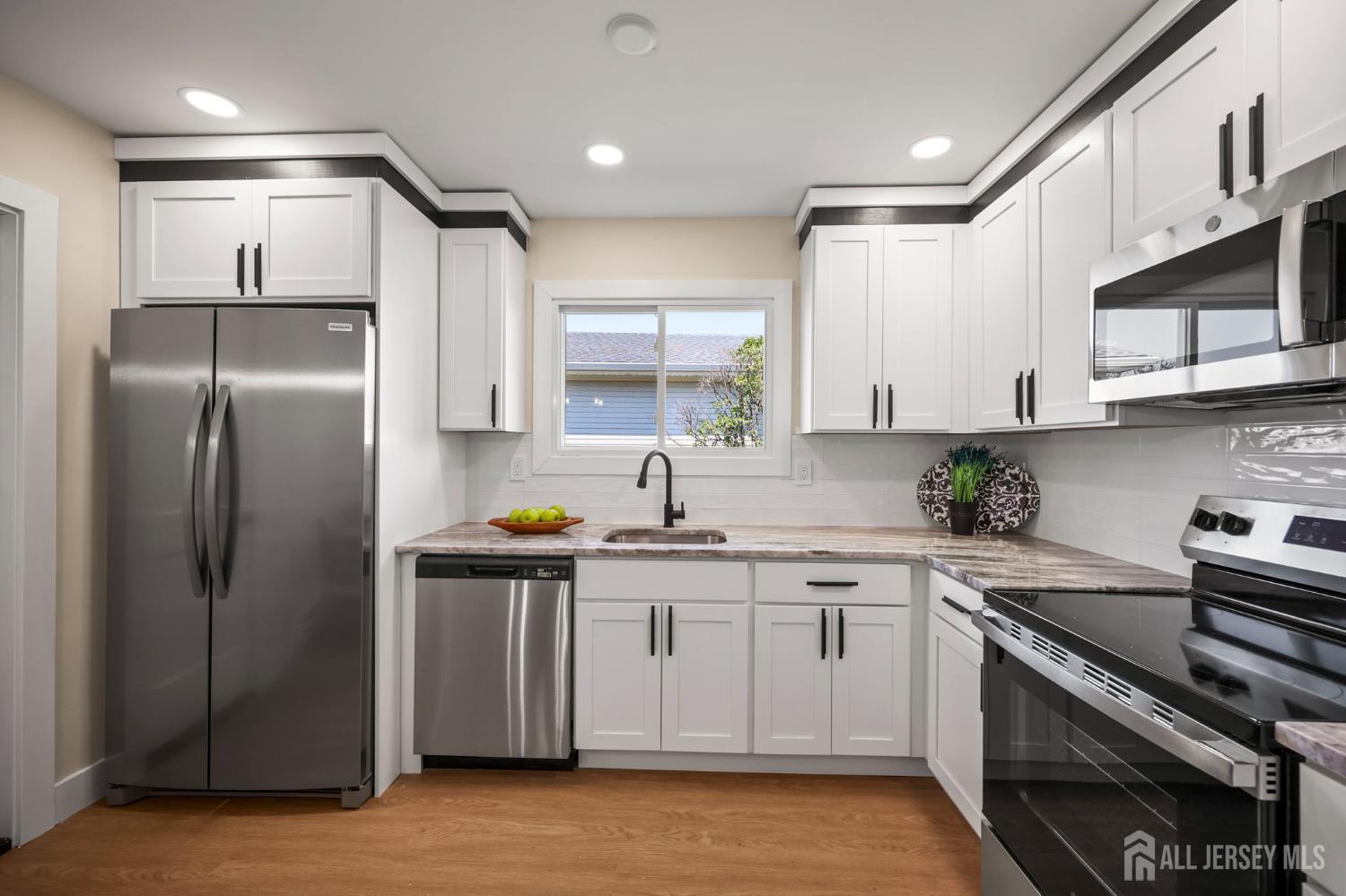 701 Croydon Road, Unit A Monroe Township, NJ 08831 - Photo 11 of 34 a kitchen with stainless steel appliances granite countertop a sink a stove a refrigerator and cabinets