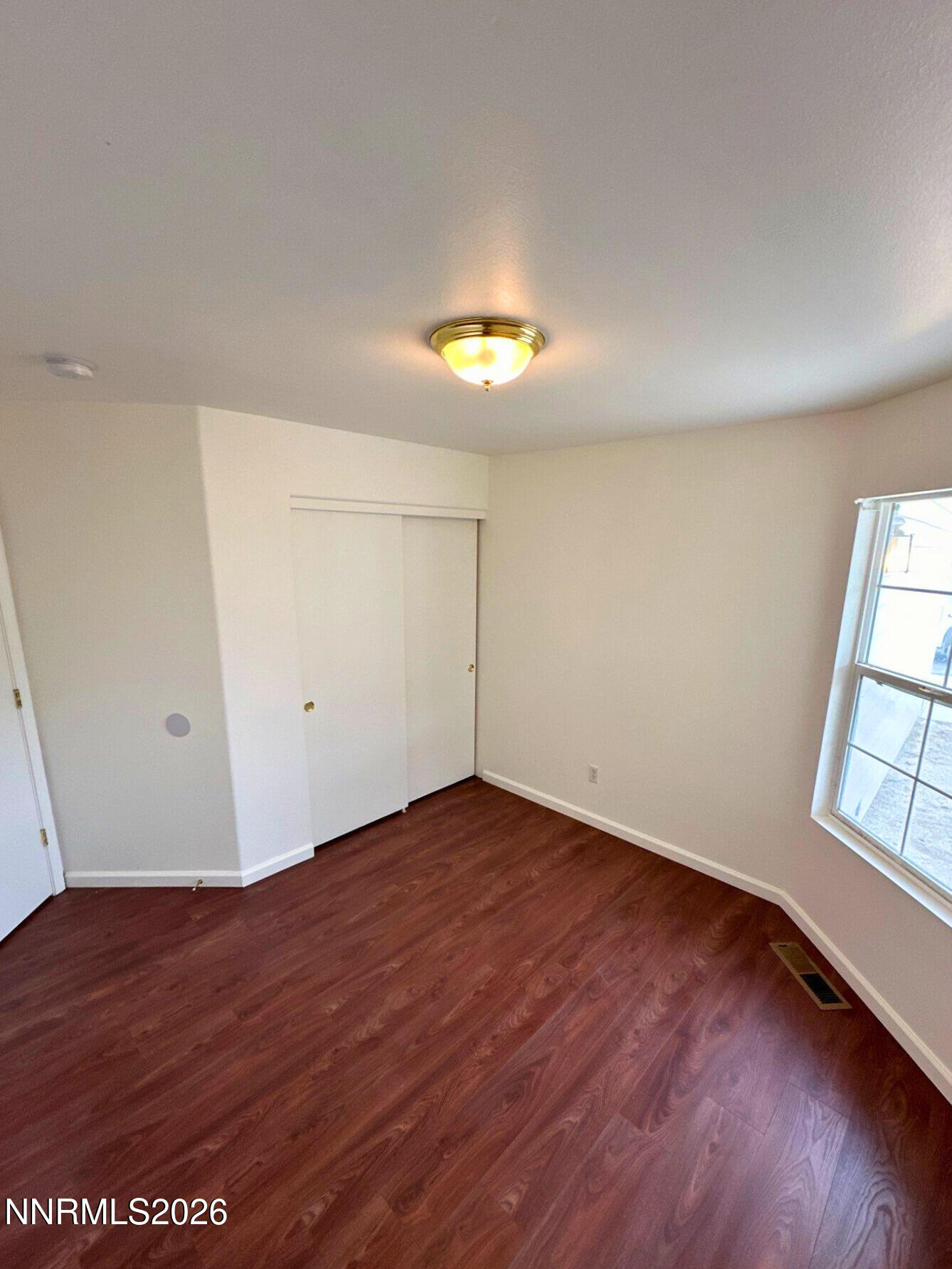 8675 Crimson Sky Court Reno, NV 89506 - Photo 11 of 16 an empty room with wooden floor and windows