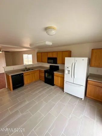a large kitchen with cabinets and stainless steel appliances