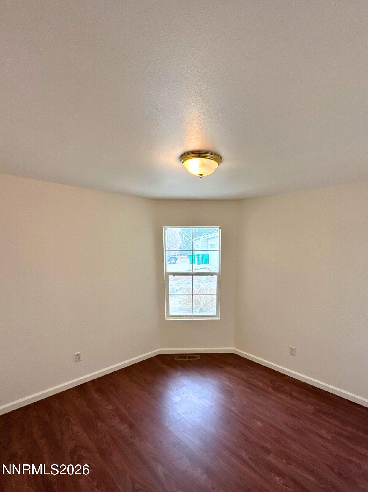 8675 Crimson Sky Court Reno, NV 89506 - Photo 10 of 16 an empty room with wooden floor and windows