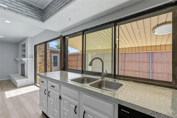 a kitchen with a sink and large window