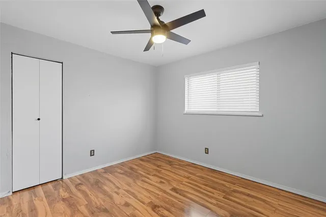 a view of a room with a ceiling fan and a window