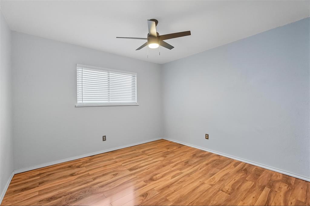 6108 Jennings Drive The Colony, TX 75056 - Photo 14 of 32 a view of a room with wooden floor and a ceiling fan