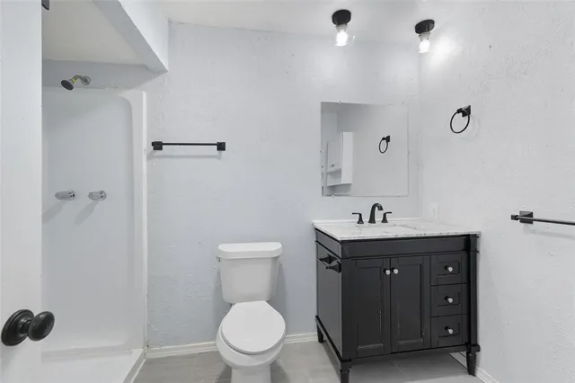 a bathroom with a toilet a sink and mirror