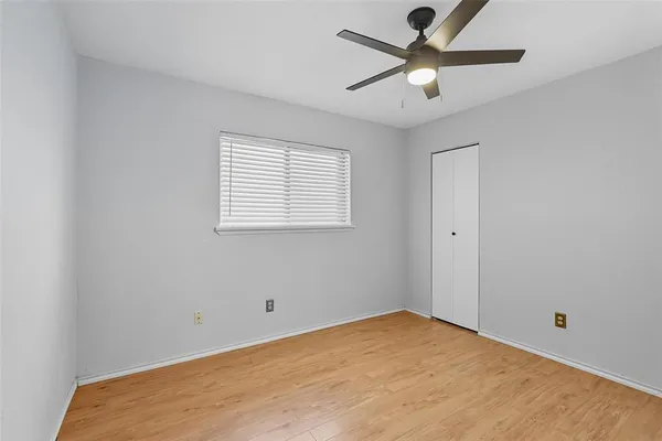 a view of a room with a ceiling fan and a window
