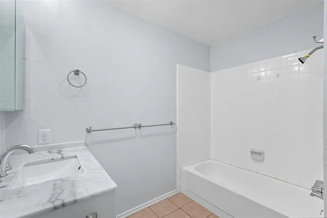 a bathroom with a bathtub and a sink