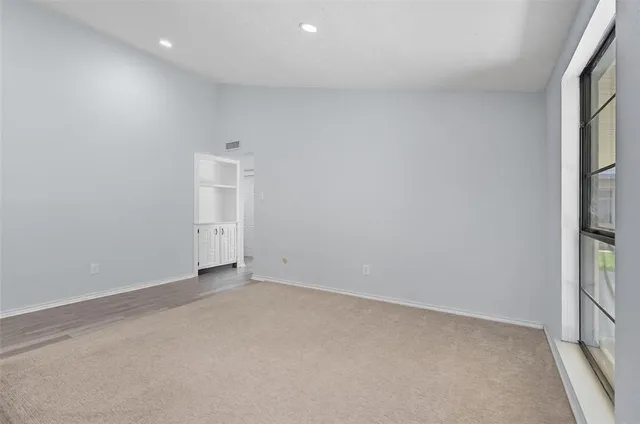 an empty room with windows and entrance