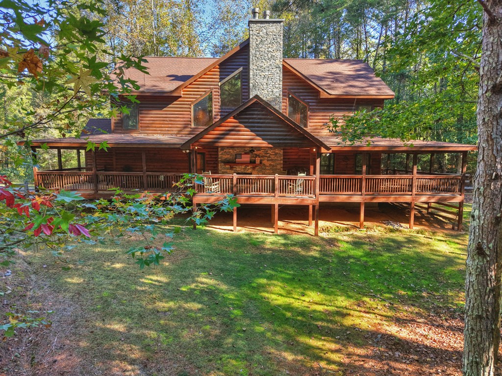 523 Long Branch Road Ranger, GA 30734 - Photo 23 of 56 a view of a backyard with table and chairs under an umbrella