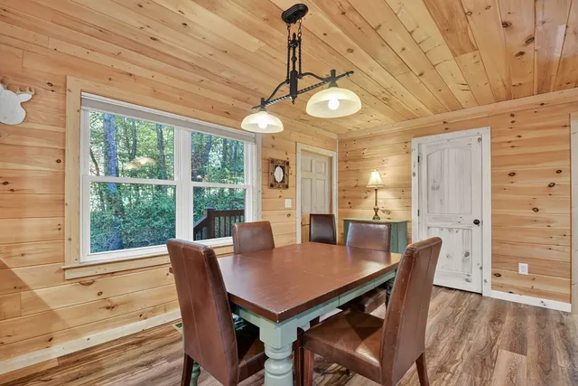 a kitchen with stainless steel appliances granite countertop a refrigerator a stove and a sink with wooden floor