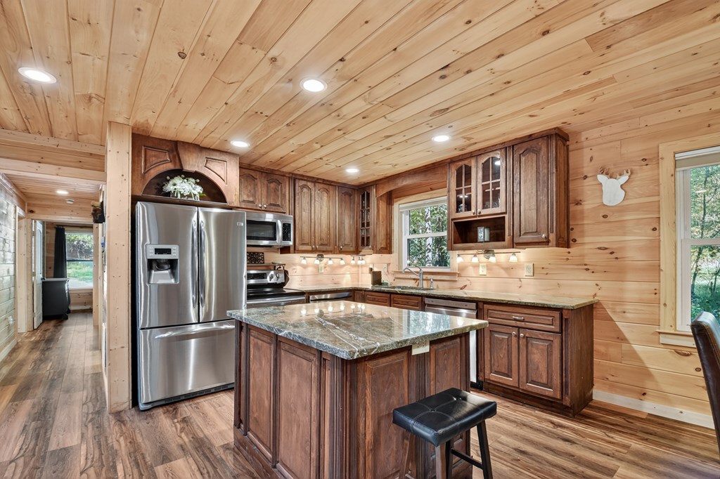 523 Long Branch Road Ranger, GA 30734 - Photo 30 of 56 a kitchen with stainless steel appliances granite countertop a sink stove and refrigerator