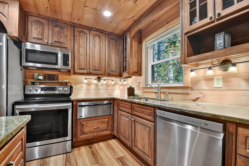 523 Long Branch Road Ranger, GA 30734 - Photo 31 of 56 a kitchen with stainless steel appliances granite countertop a sink a stove and microwave