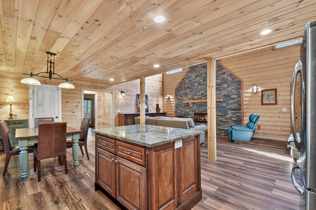 523 Long Branch Road Ranger, GA 30734 - Photo 33 of 56 a kitchen with a stove dining table chairs and wooden floor
