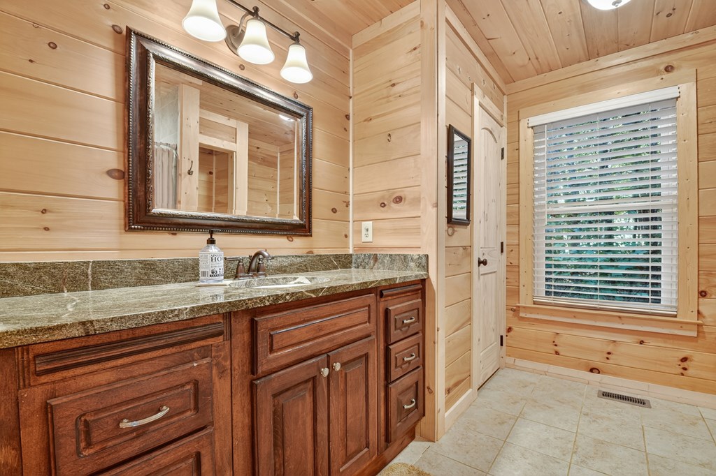 523 Long Branch Road Ranger, GA 30734 - Photo 35 of 56 a bathroom with a granite countertop sink and a mirror