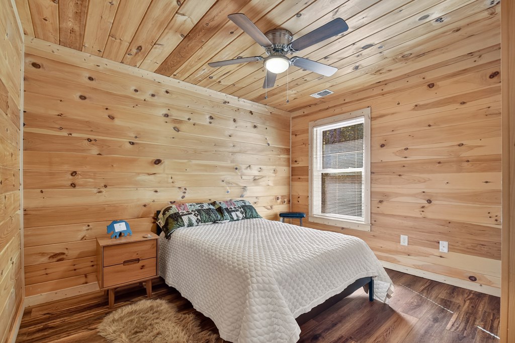 523 Long Branch Road Ranger, GA 30734 - Photo 48 of 56 a spacious bedroom with a bed and a flat tv screen