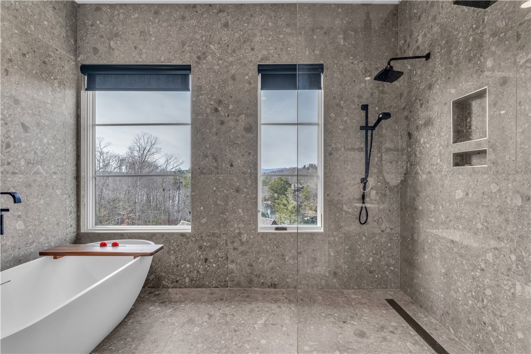 127 Crosswind Court Sunset, SC 29685 - Photo 18 of 49 This serene bathroom offers a spa-like escape with natural light and a modern soaking tub.