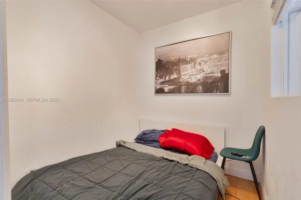 a bedroom with a bed and a chair