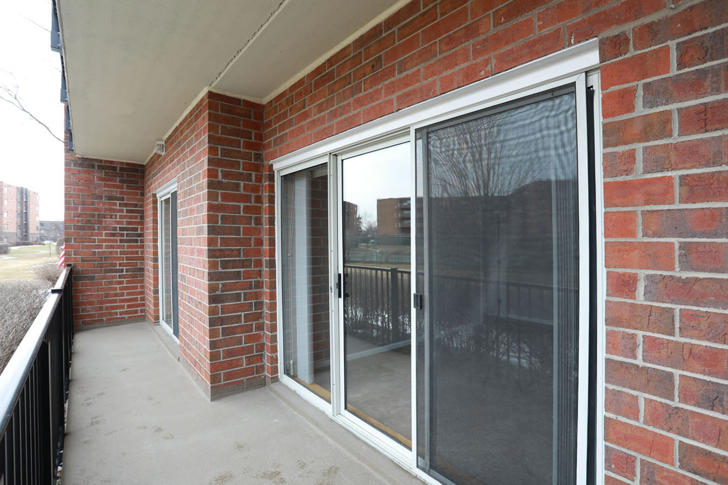 815 Leicester Road, Unit 108 Elk Grove Village, IL 60007 - Photo 23 of 34 a view of a brick house with a glass door