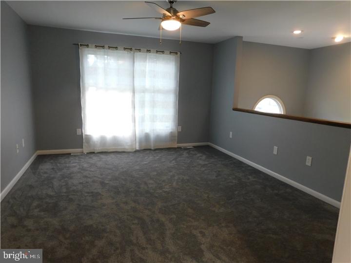 35 Cimarron Circle Elkton, MD 21921 - Photo 4 of 17 en empty room with windows and chandelier fan