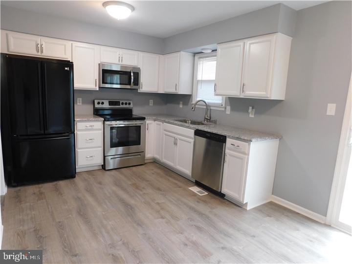 35 Cimarron Circle Elkton, MD 21921 - Photo 5 of 17 a kitchen with granite countertop white cabinets and stainless steel appliances