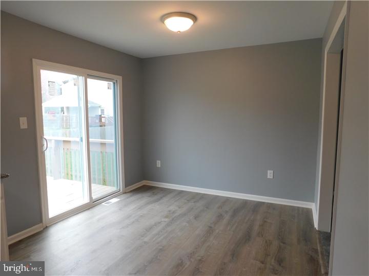 35 Cimarron Circle Elkton, MD 21921 - Photo 7 of 17 an empty room with wooden floor and windows