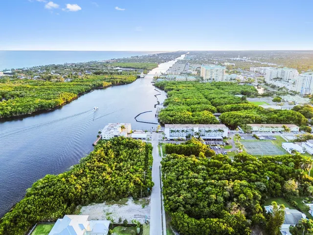 view of a lake with houses in the back