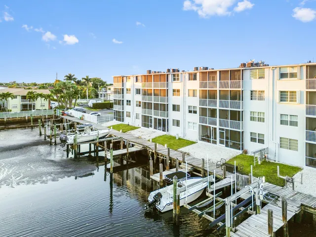 a view of a hallway with wooden floor and a living room