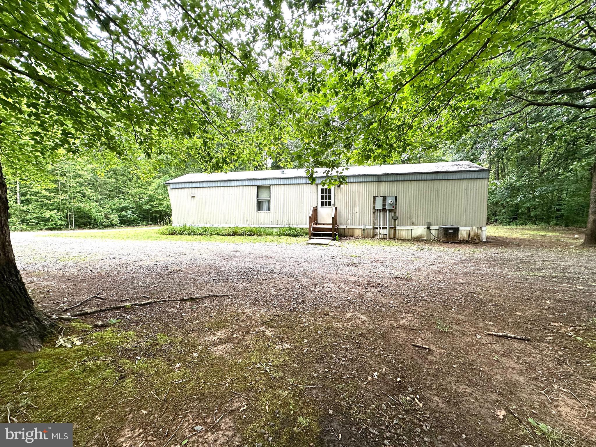 606 Dogwood Acres Road Bumpass, VA 23024 - Photo 15 of 20 a white house that has a tree in front of it