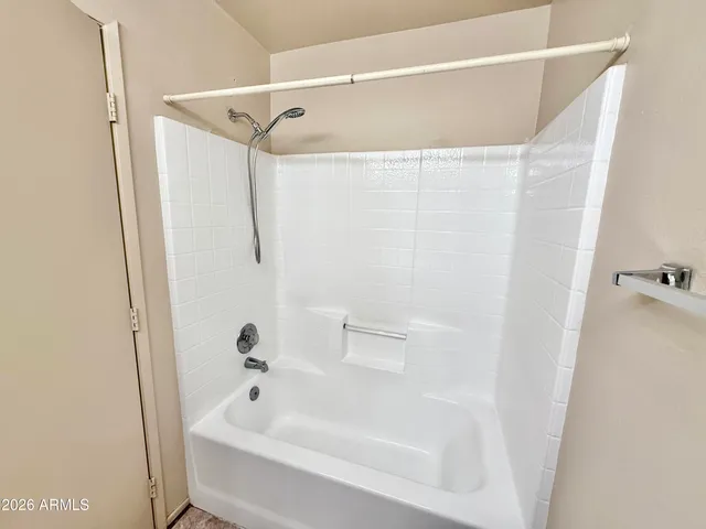 a bathroom with a bathtub and shower